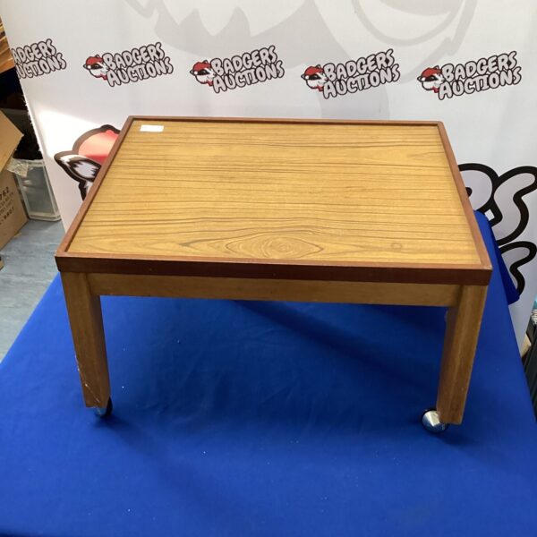 Vintage wheeled magazine table with wooden construction.