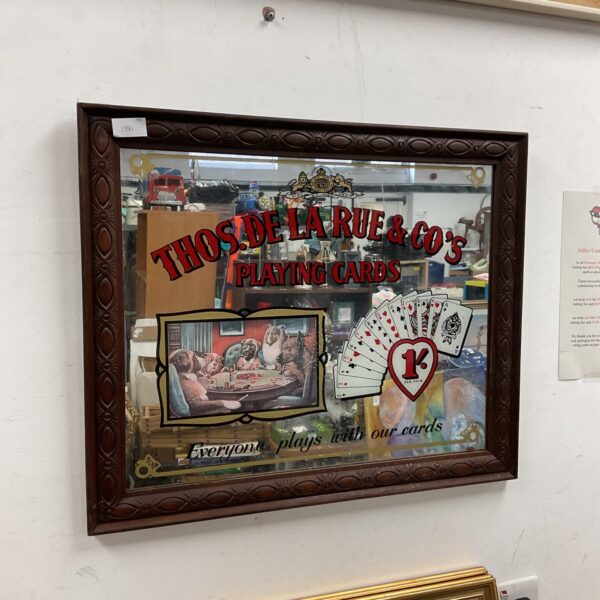 Antique Thos De La Rue pub mirror with oak frame and playing card design.
