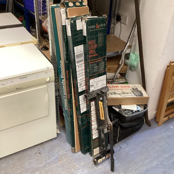 Oak and Grey laminate flooring bundle with cutter for DIY projects.