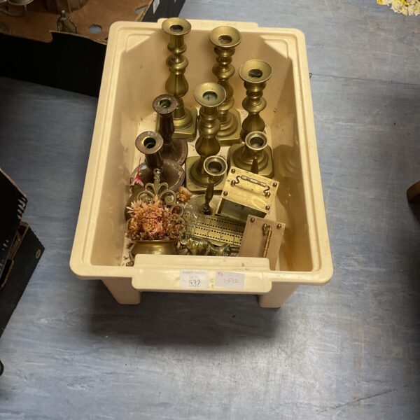Vintage brass collectibles lot including candlesticks and clock parts.