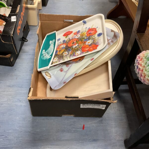 Vintage plastic serving trays with colourful floral designs.