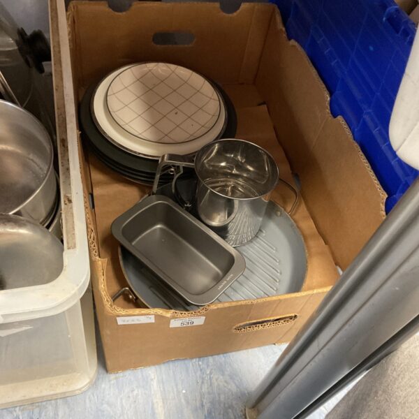 Mixed crockery lot with ceramic plates and serving dishes.