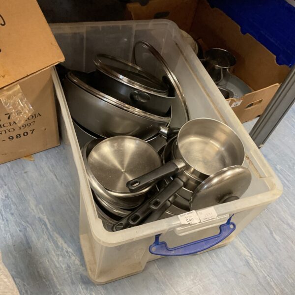 Mixed lot of stainless steel pots and pans for kitchen use.