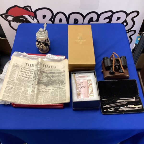Mixed lot featuring Glenmorangie whiskey case and vintage newspaper.