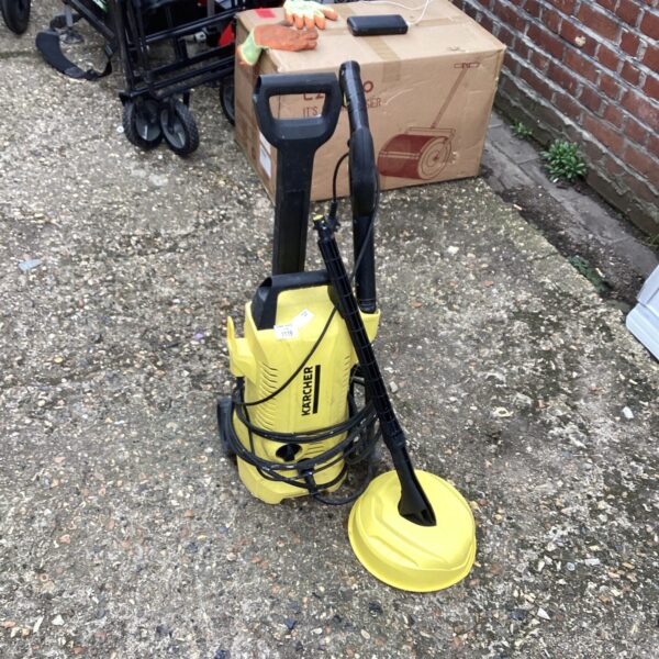Yellow Karcher power washer with spray lance attachment.