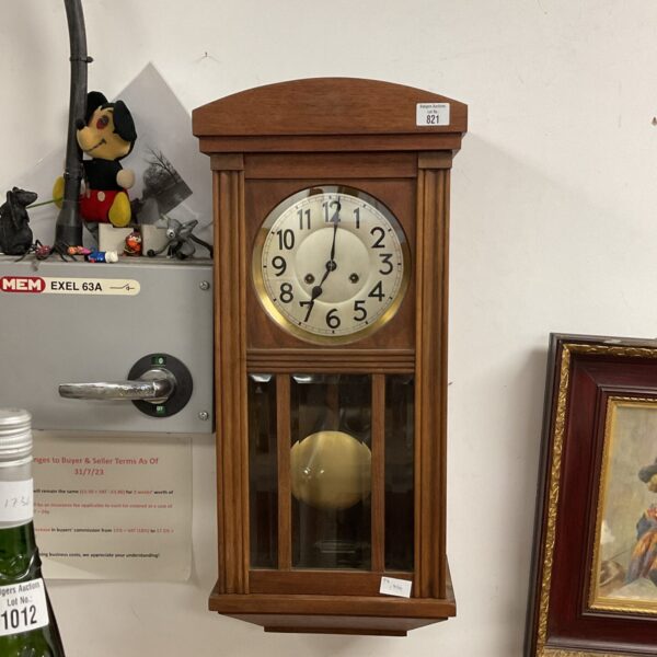 Vintage Junghans wall clock with a white dial and black numerals.