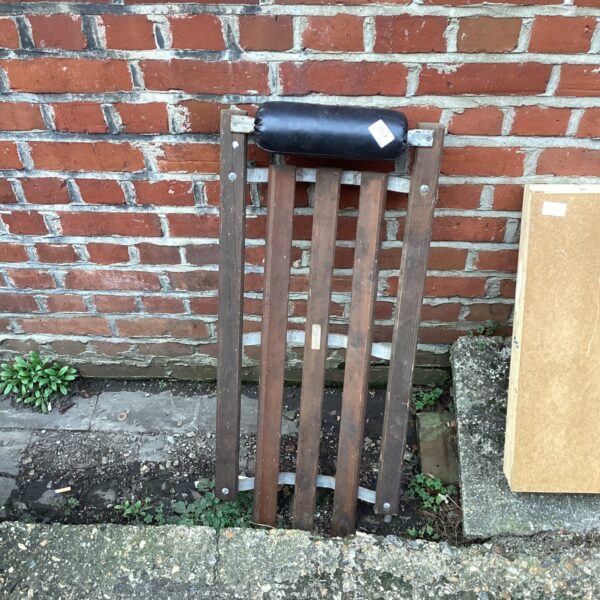 Vintage wooden under car crawler for automotive repair.