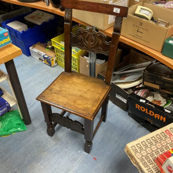 Antique 18th-century hand-carved oak chair with floral detailing.