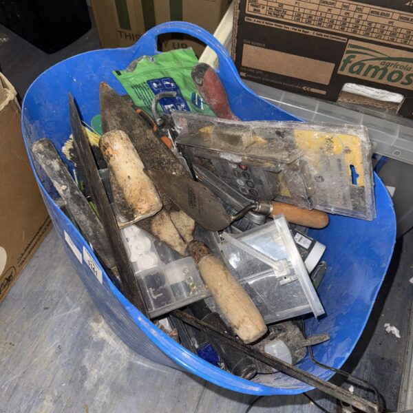 Large bucket of assorted tools and hardware for DIY projects.