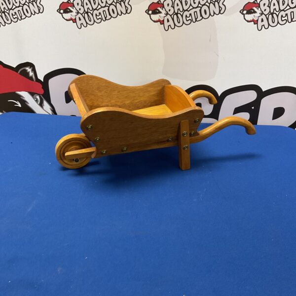 Rustic wooden wheelbarrow decoration for garden or home display.