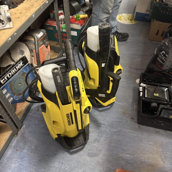 Yellow and black Karcher pressure washer for garden cleaning.
