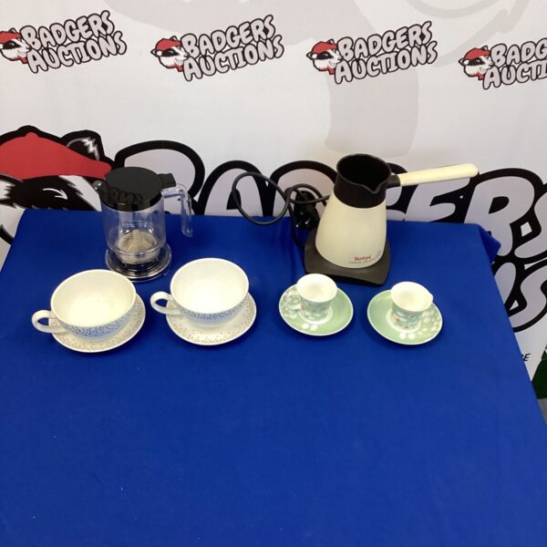 Vintage Tefal coffee and tea maker set with cups and saucers on display.