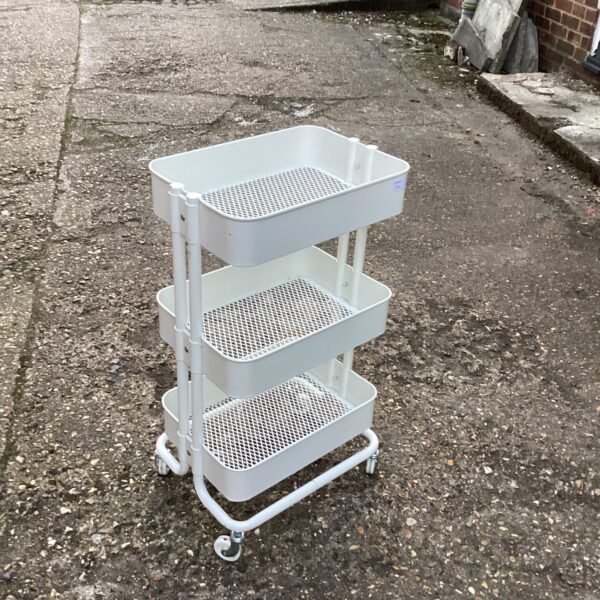 White metal work caddy with three tiers and caster wheels.