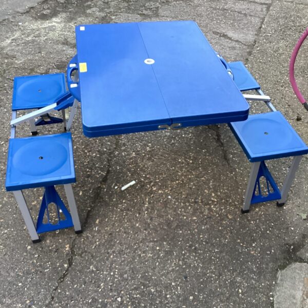 Blue folding picnic table with benches, ideal for outdoor use.