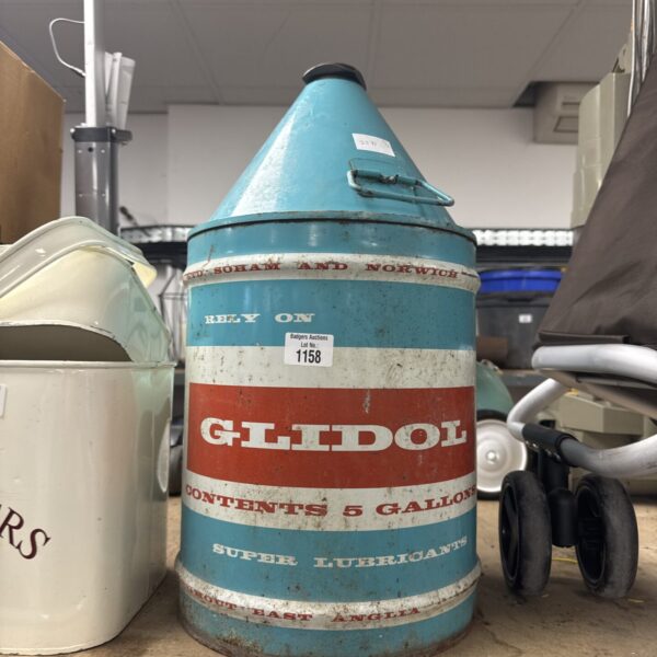Vintage Glidol 5 gallon oil drum with bold advertising graphics.