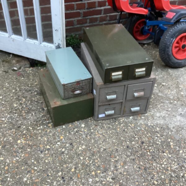 Vintage metal storage drawers with signs of wear and rust.