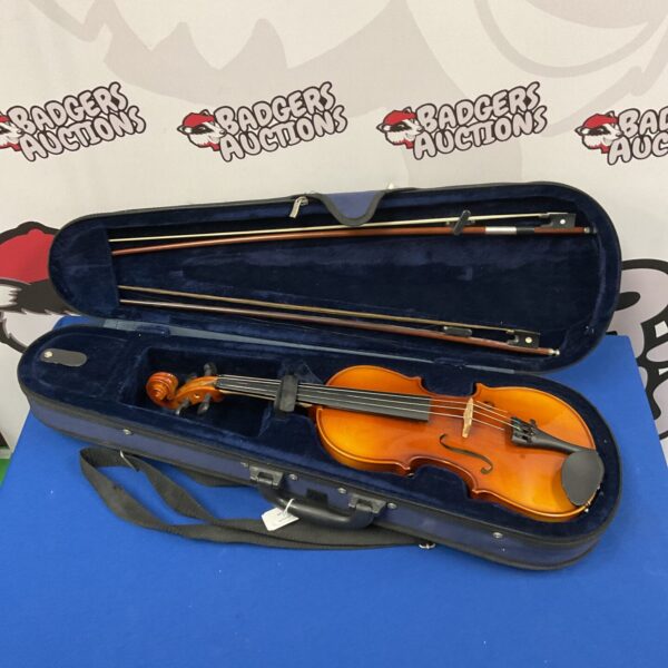 Vintage violin with two bows inside a protective case.