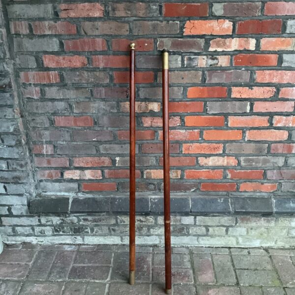 Vintage flag pole with brass detailing, mid-century display item.