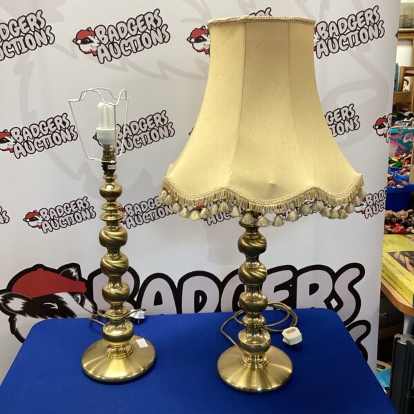 Pair of large brass table lamps with cream shades.