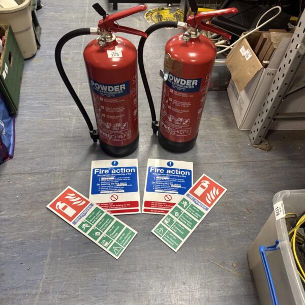 Pair of vintage red powder fire extinguishers for fire safety.
