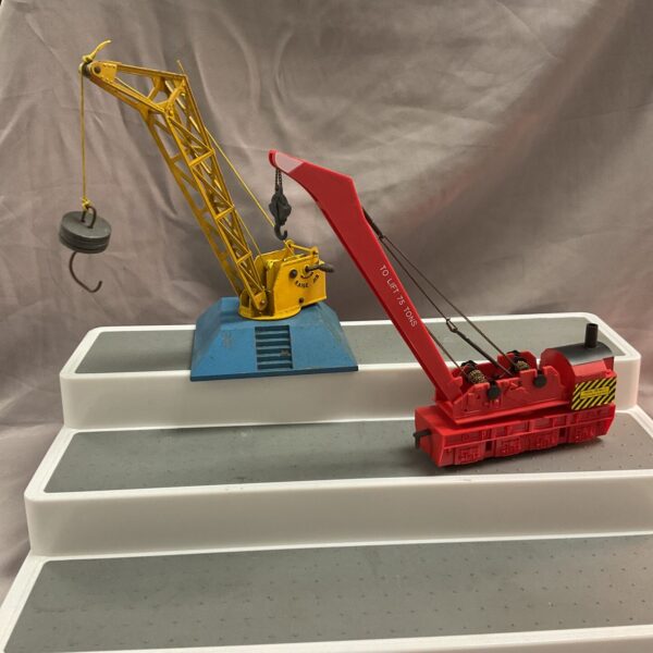 Vintage diecast crane with hook and rotating base.