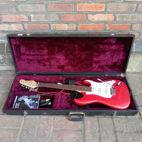 Red Cheetah electric guitar in a lined hard case.
