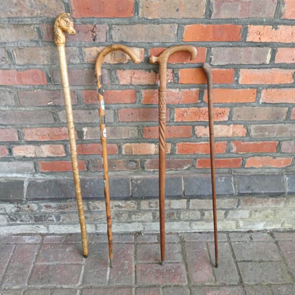 Vintage walking stick lot with horse head detail.