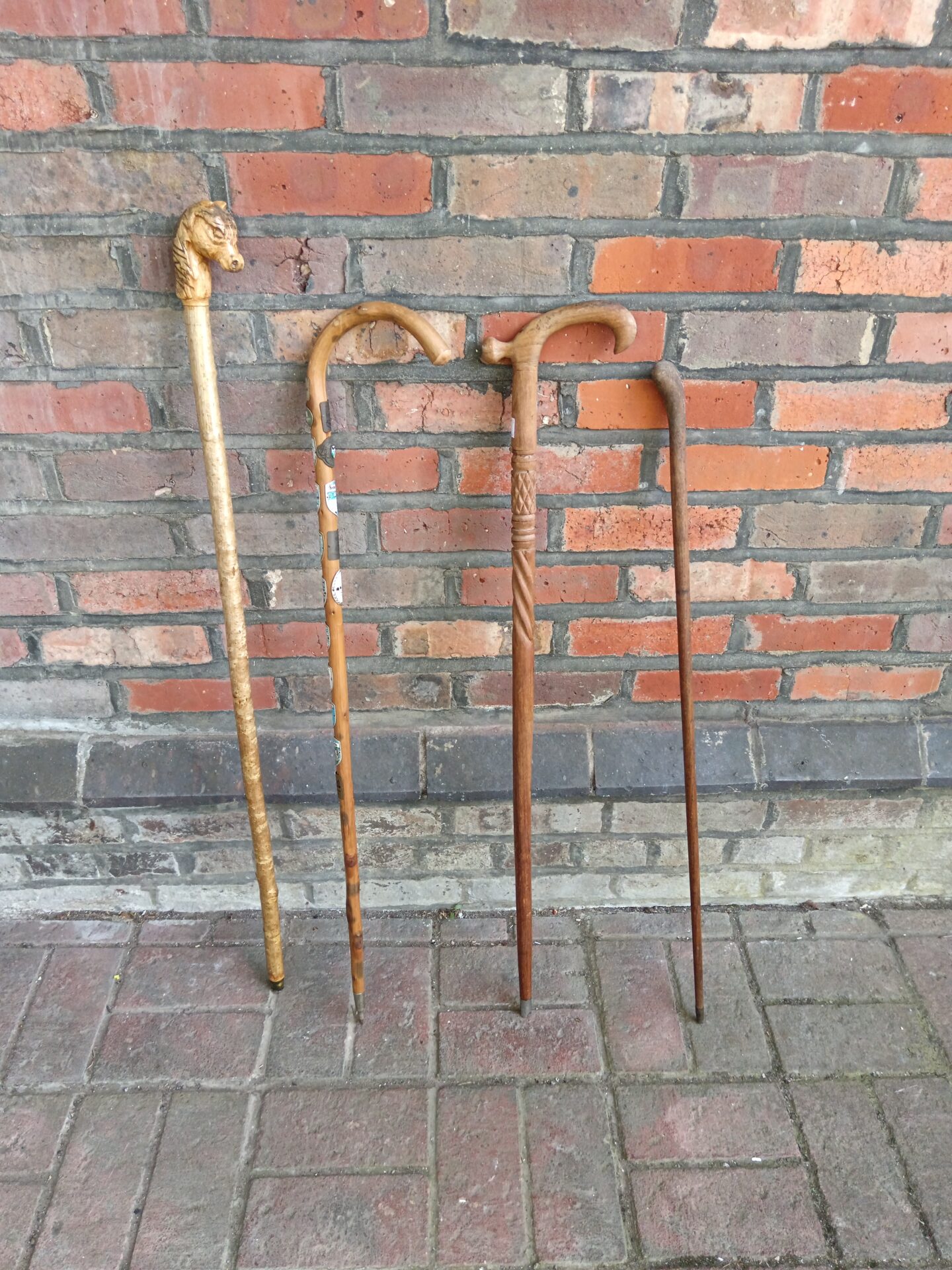 733 Four vintage walking sticks including horse head stick & one with travel plaques