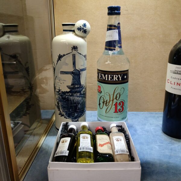 Sealed alcohol lot featuring Emery Ouzo and Augadomino bottles.