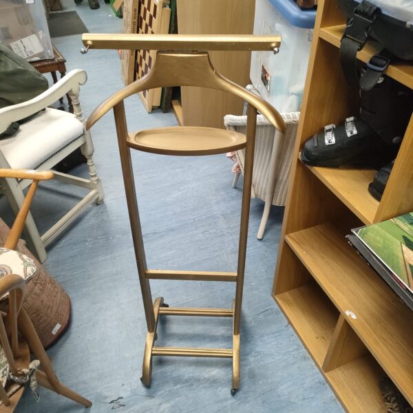 Vintage gold-tone suit rack for coats and hats.