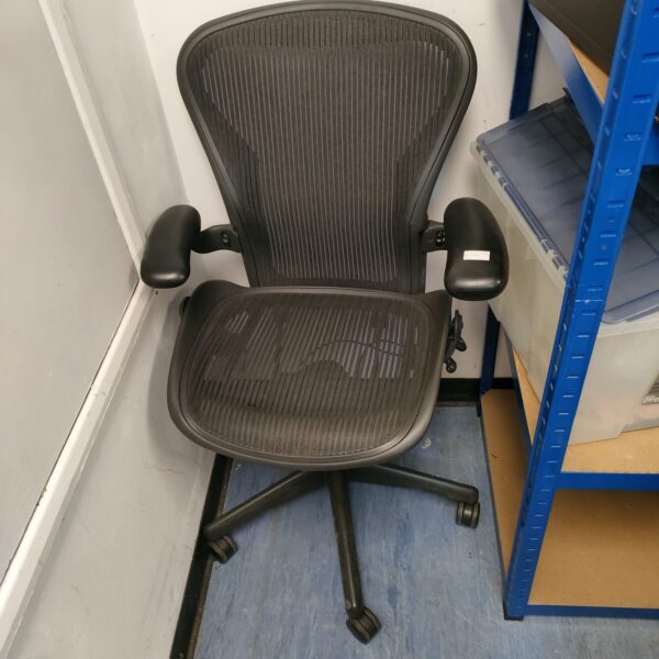 Black Herman Miller Aeron ergonomic office chair with mesh back.