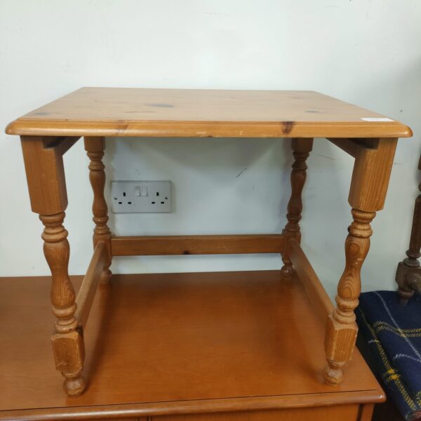 Small pine side table with turned legs and lower shelf.