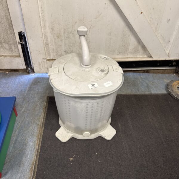 Vintage camping clothes washer with hand crank for portable laundry.