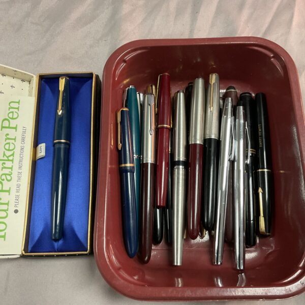 Tray of assorted vintage Parker pens and other writing instruments.