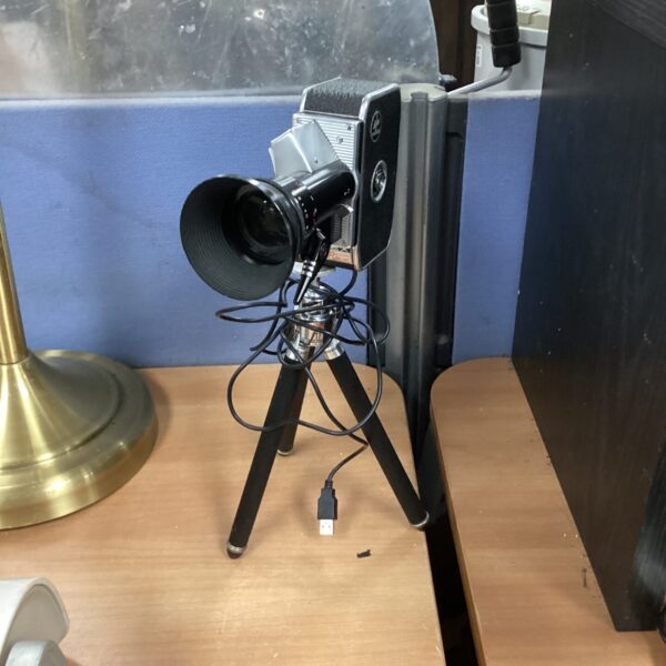 Vintage Bolex camera repurposed as a unique desk lamp.