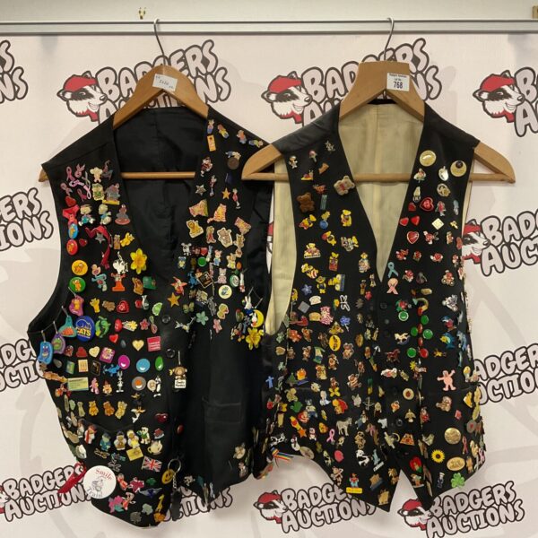 Pair of waistcoats covered in colourful pin badges.