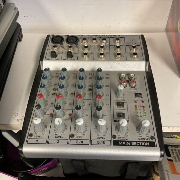 Behringer Eurorack UB802 mixer with controls visible.