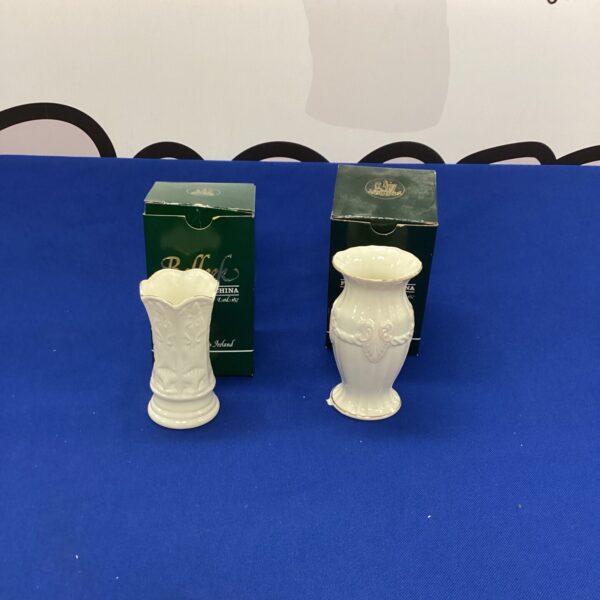 Pair of antique Belleek porcelain vases with floral details.
