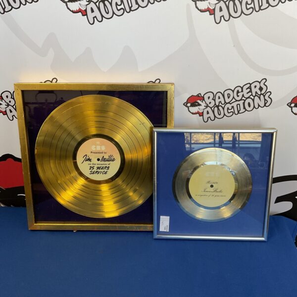 Framed CBS long service gold and silver awards discs.