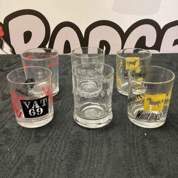 Vintage whiskey tumblers featuring King George IV and VAT 69 branding.