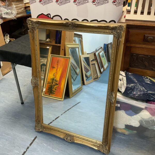 Ornate vintage gilt framed rectangular mirror for wall decoration.