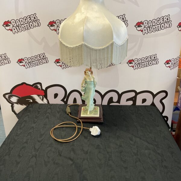 Vintage table lamp with floral design and fringed shade.