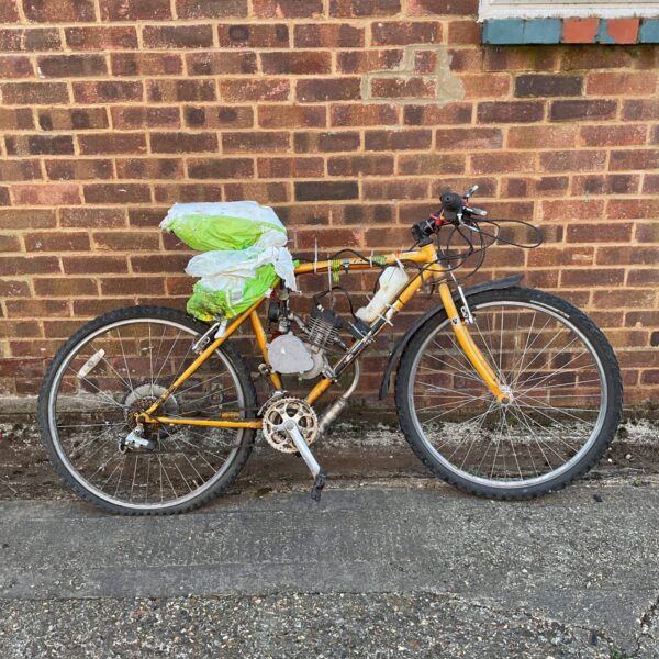 Vintage GT mountain bike with 2-stroke engine modification.