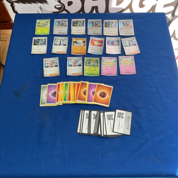 Overview of a diverse Pokemon card lot with holo and energy cards.