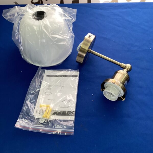 Brass wall light in original packaging, vintage style.