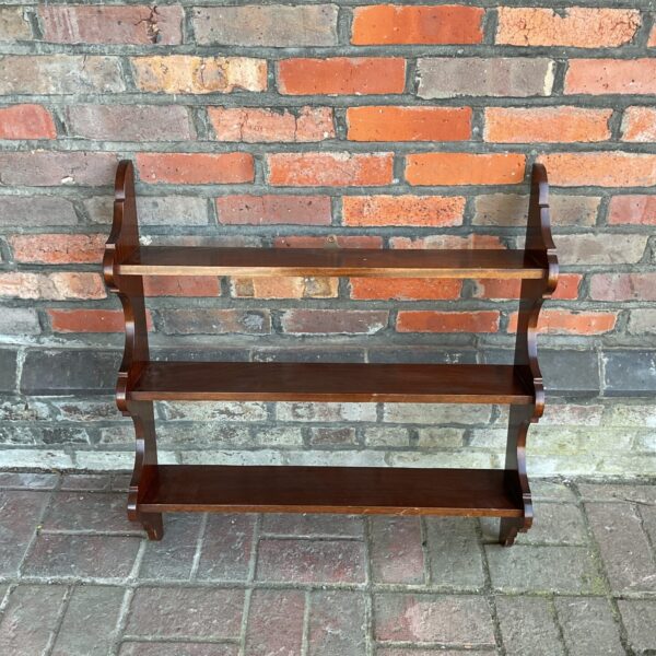 Vintage mahogany wall shelving unit with three tiers.