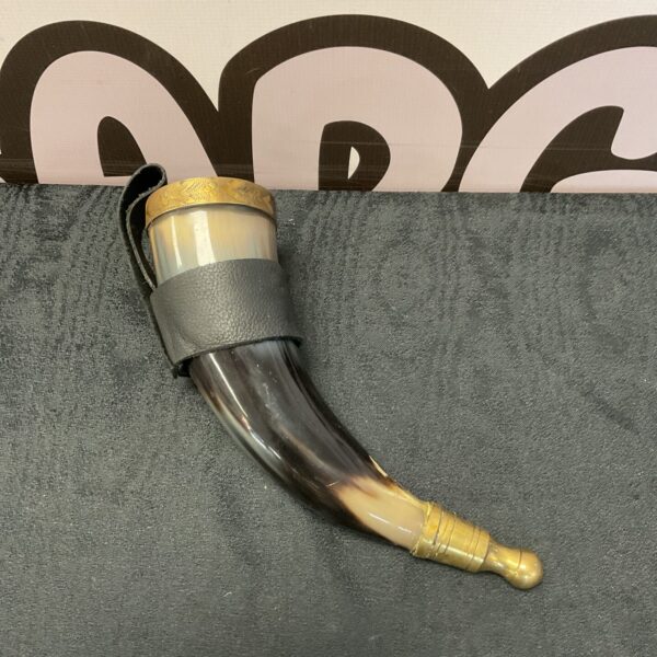 Gilded drinking horn with leather strap, medieval style vessel.