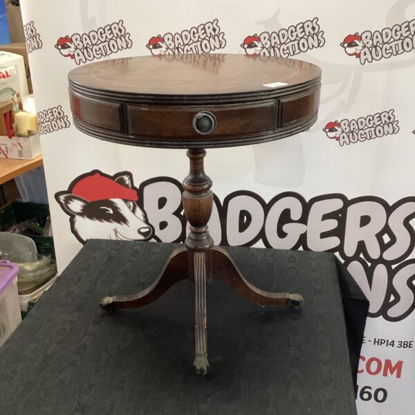 Vintage mahogany drum table with curved legs and circular top.