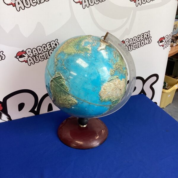 Vintage Rico world globe on wooden base, detailed cartography.