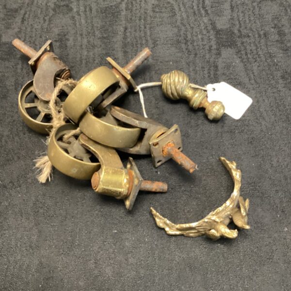 Antique brass castor wheels and turtle dove sculptures, vintage brassware.